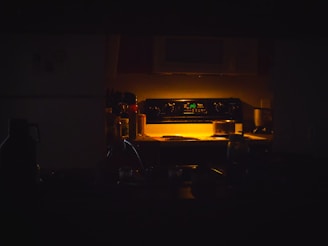 A dimly lit kitchen with oven light.
