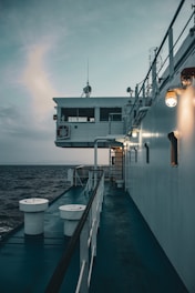 A ship's deck overlooks a calm ocean.