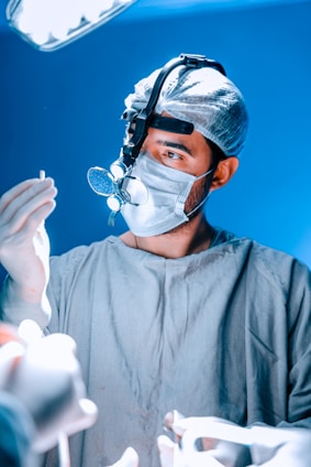 A surgeon examines a medical instrument during surgery.