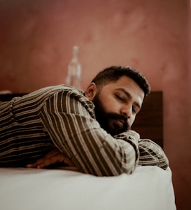 Man sleeping peacefully on a bed.