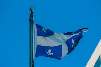 The flag of quebec waves in the wind.