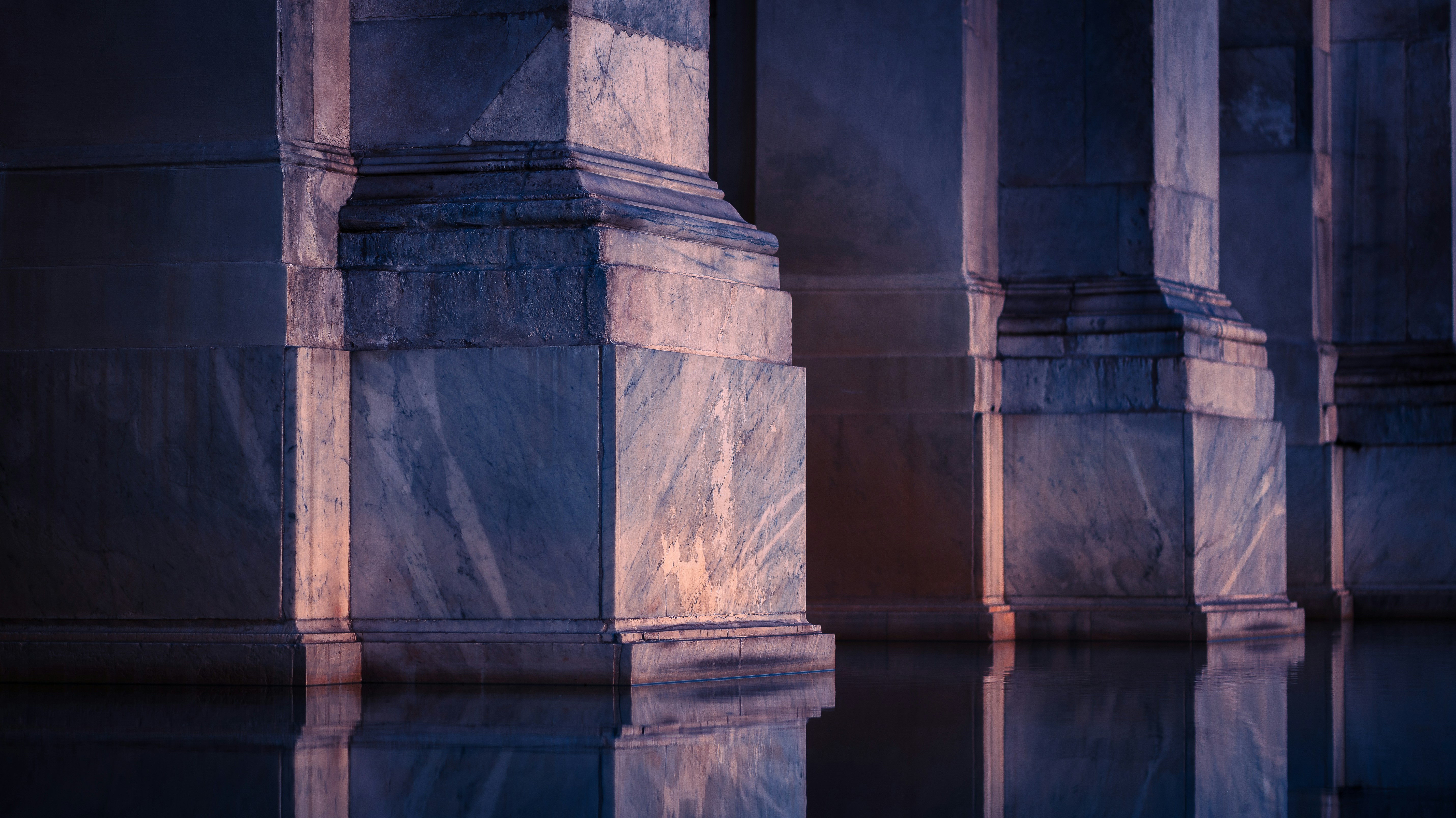 Reflections of marble columns in water.