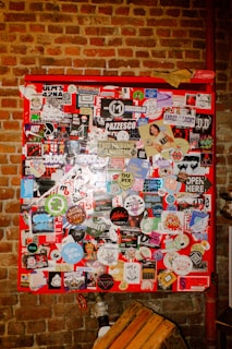 Red board is covered in stickers.