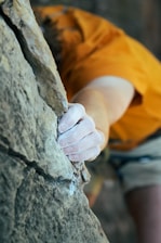 A climber holds onto the rocky surface.