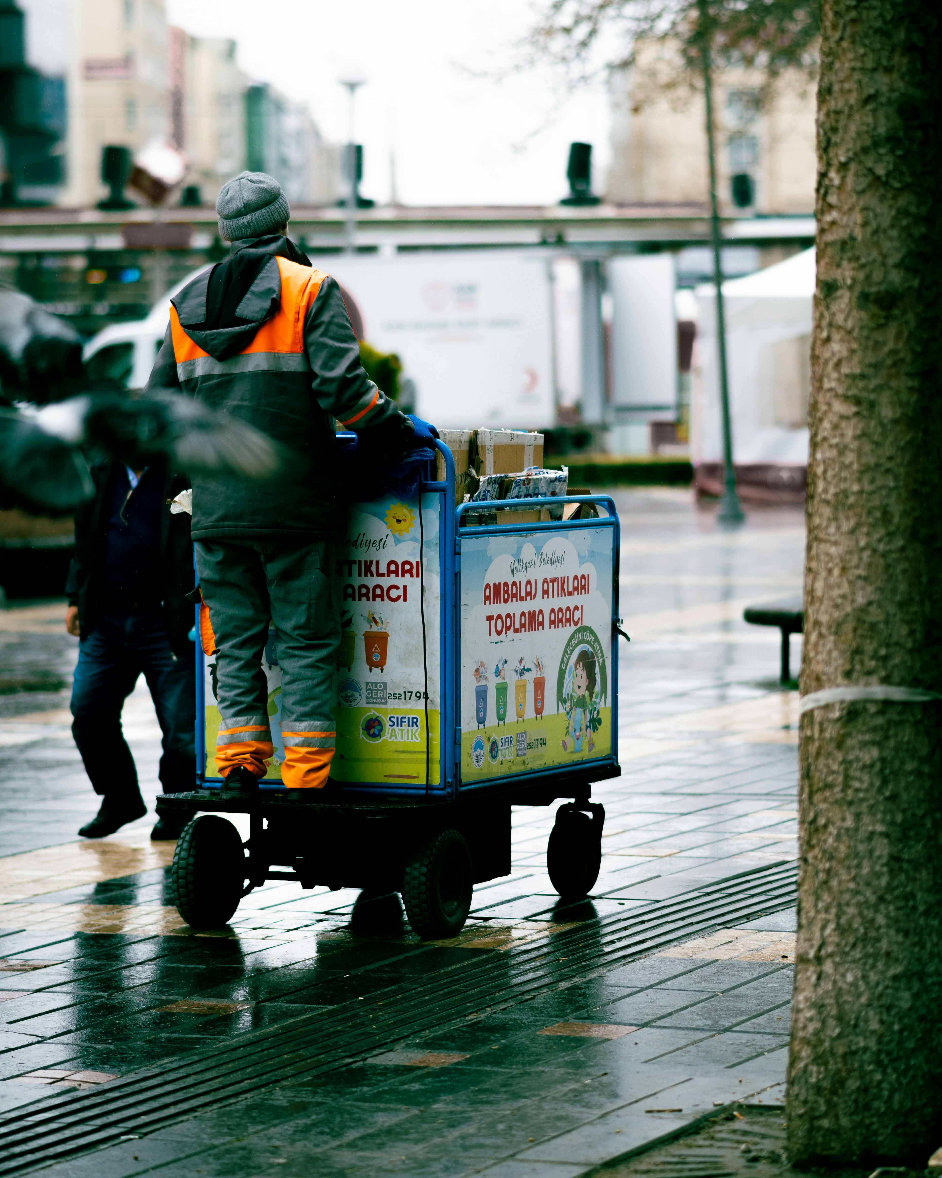 A sanitation worker on the job, collecting trash.