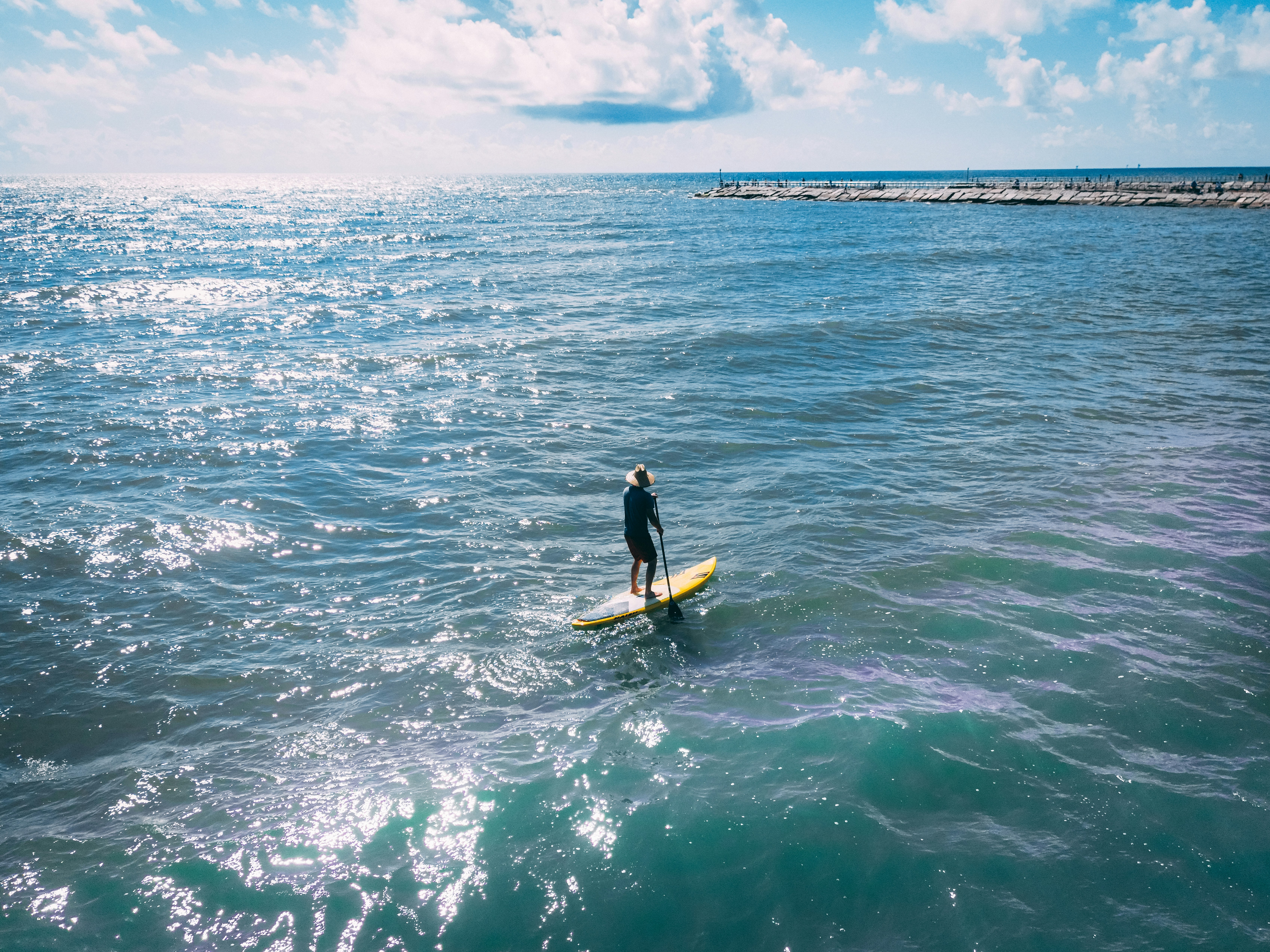 A person surfs alone on the ocean waves.