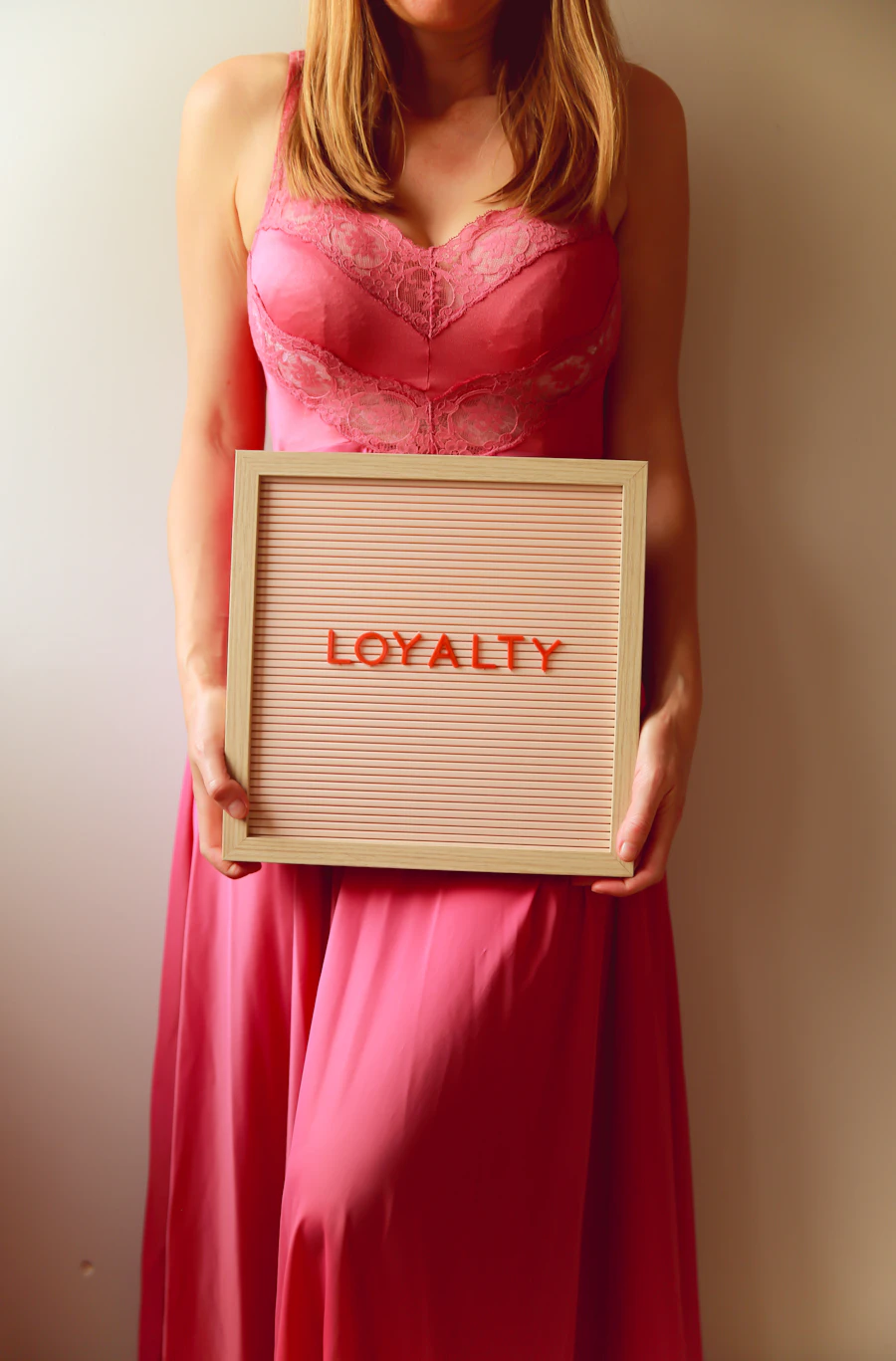 Woman holding a sign that says loyalty