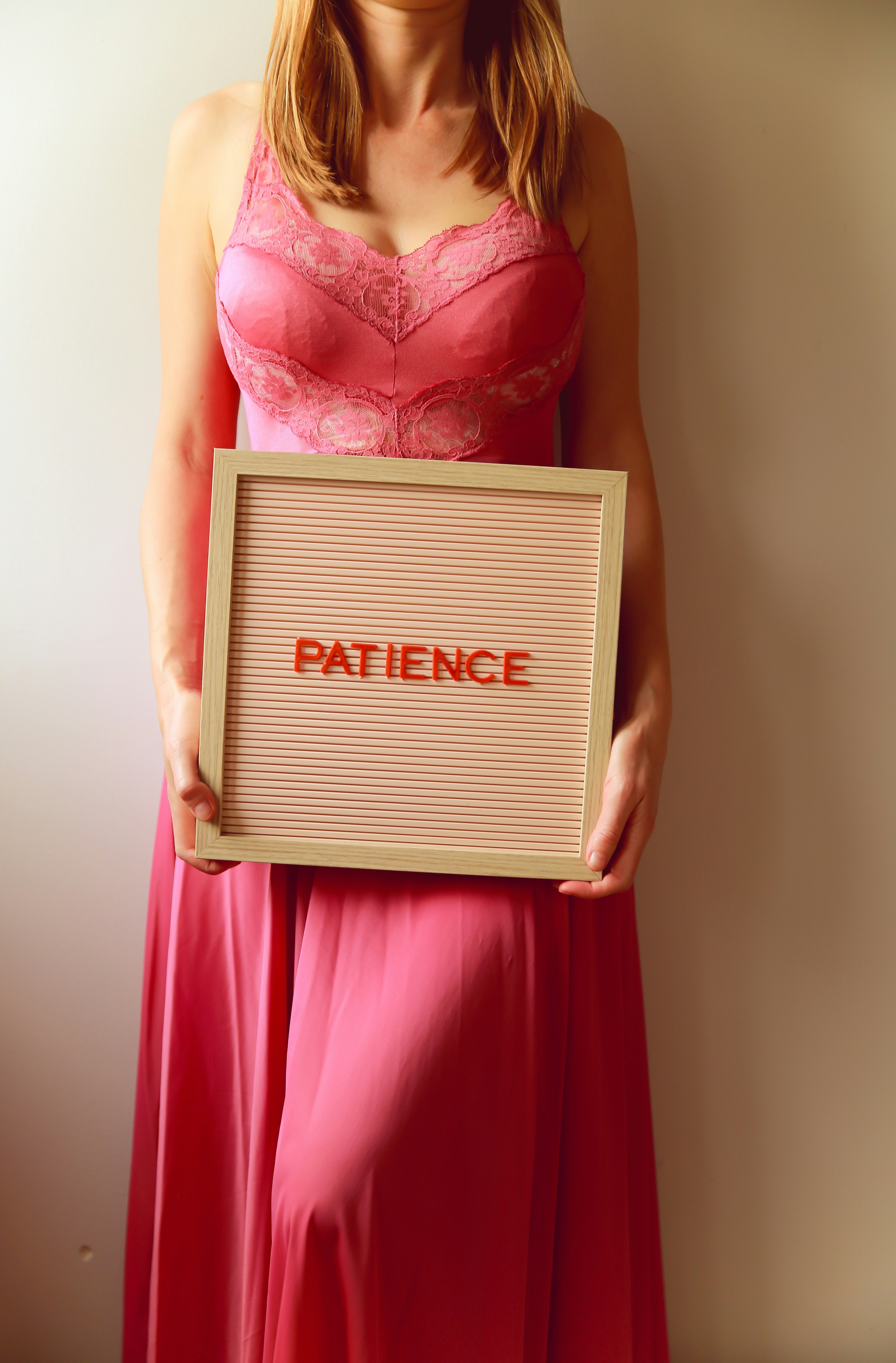 Woman holds a sign that says "patience".