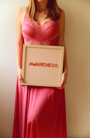 Woman holds a sign that says "awareness".