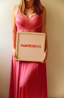 Woman holds a sign that says "awareness".