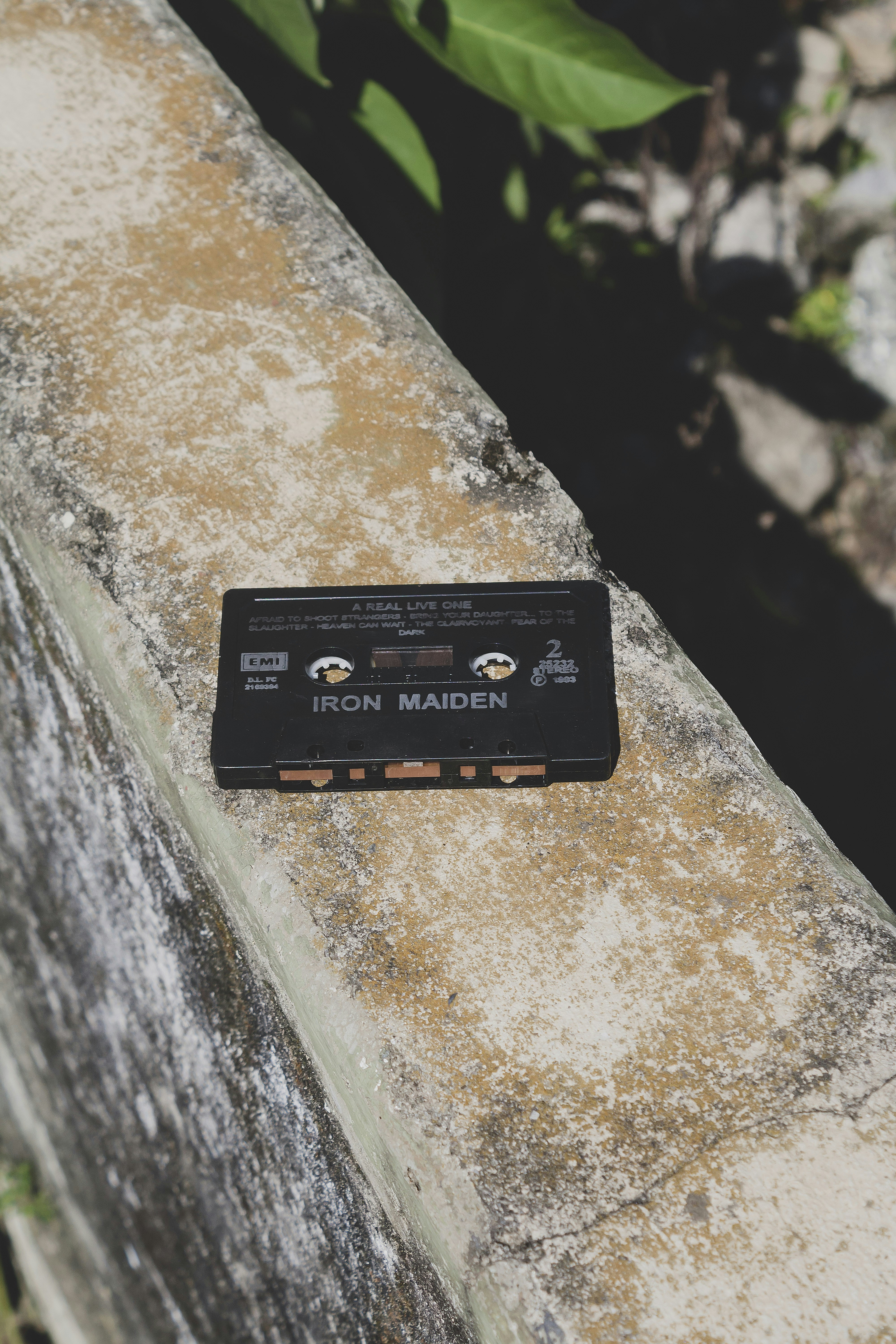 An iron maiden cassette tape sits on a ledge.