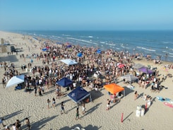 People are gathering on the beach for a party.