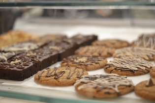 Delicious cookies and brownies displayed in a bakery.