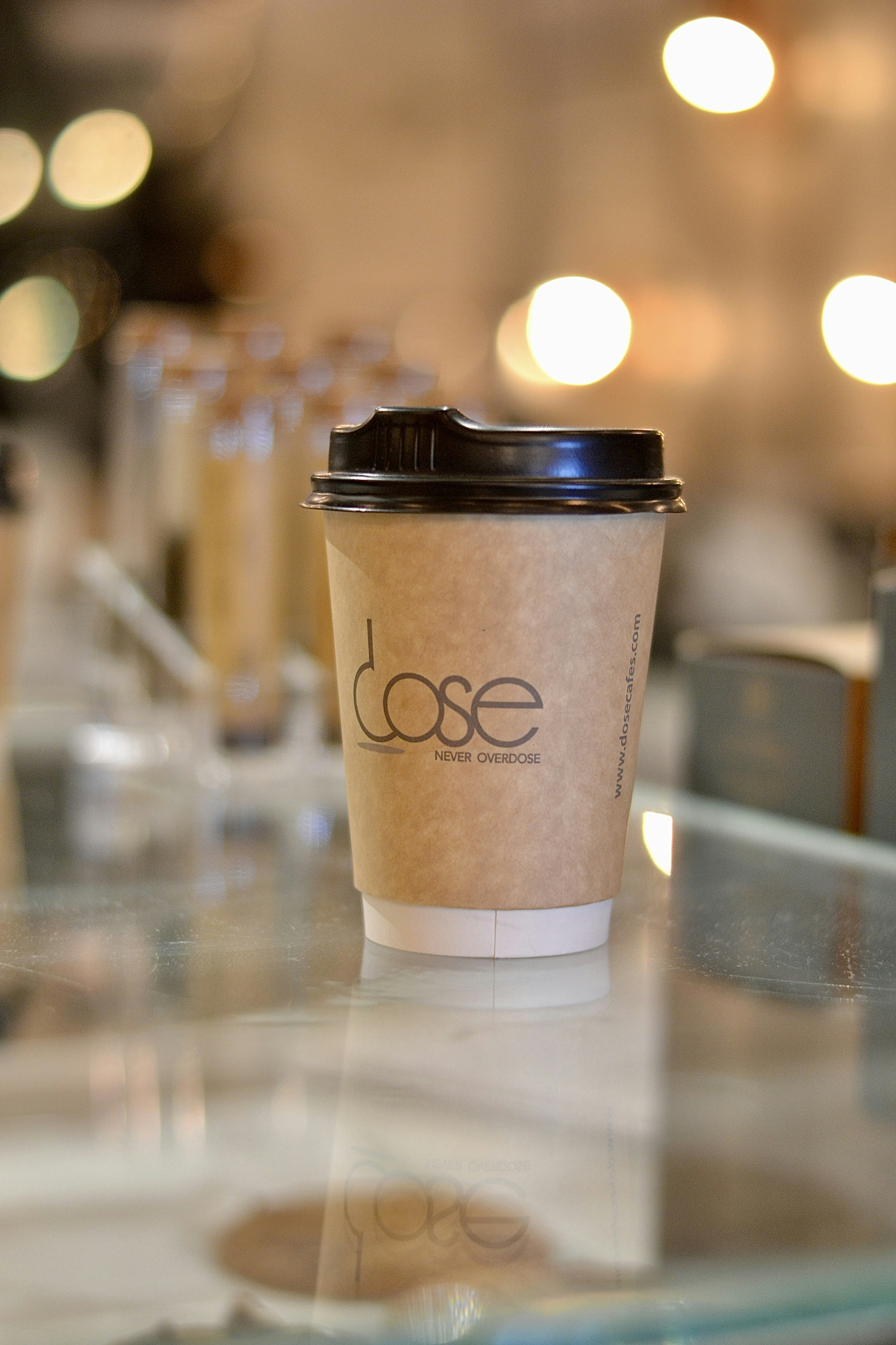 A coffee cup sits on a glass table.