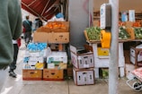 Fresh produce stands on a sidewalk.