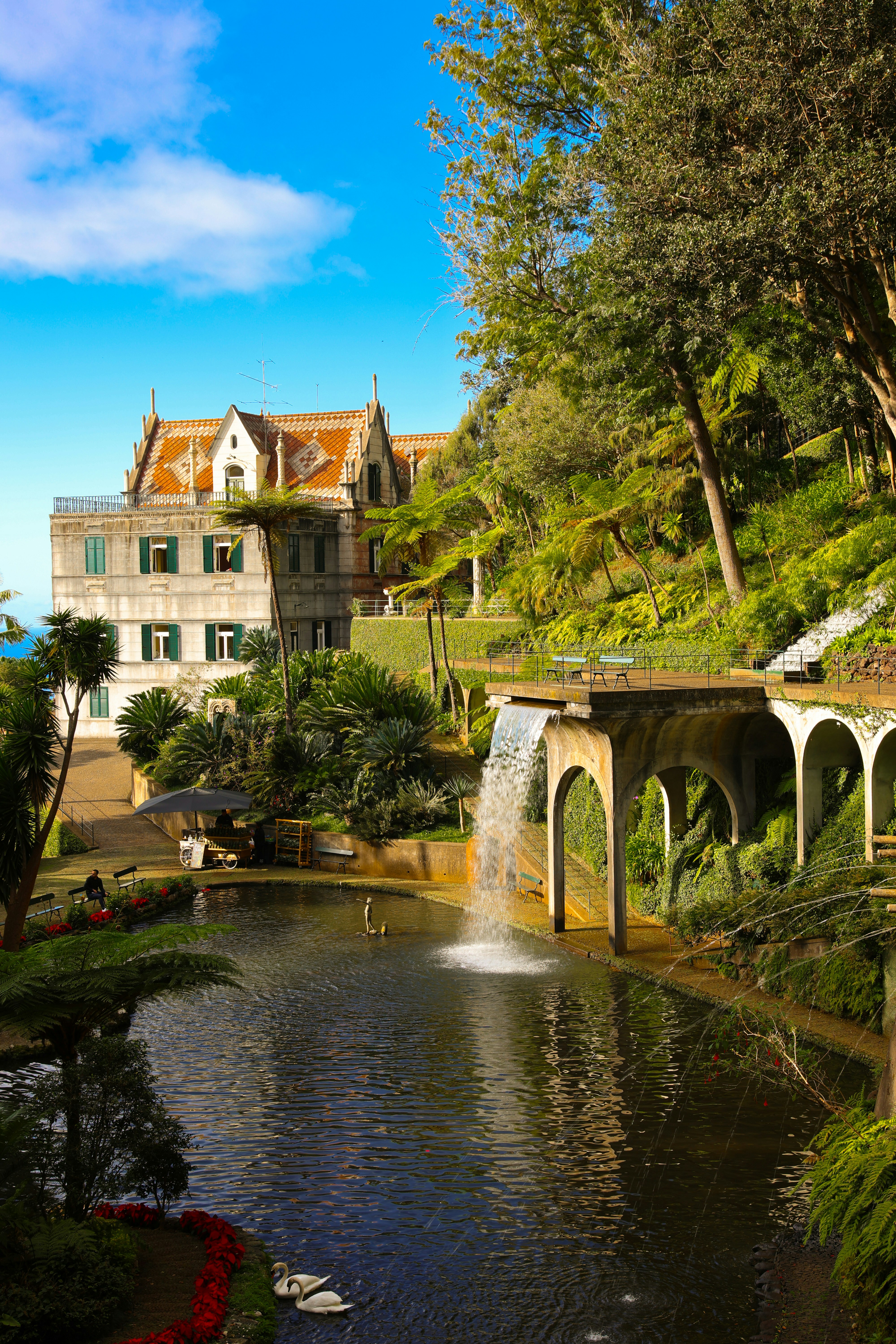 Beautiful waterfall and estate in a sunny garden.