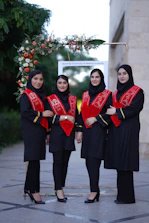 Four female graduates pose for a photo.