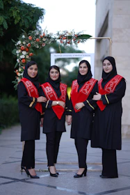 Four female graduates pose for a photo.