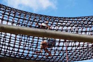 A child climbs across a rope net.