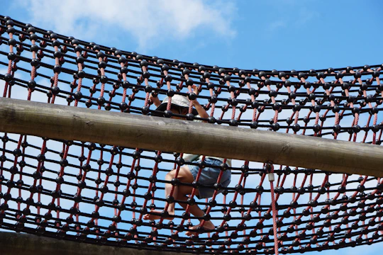 A child climbs across a rope net.