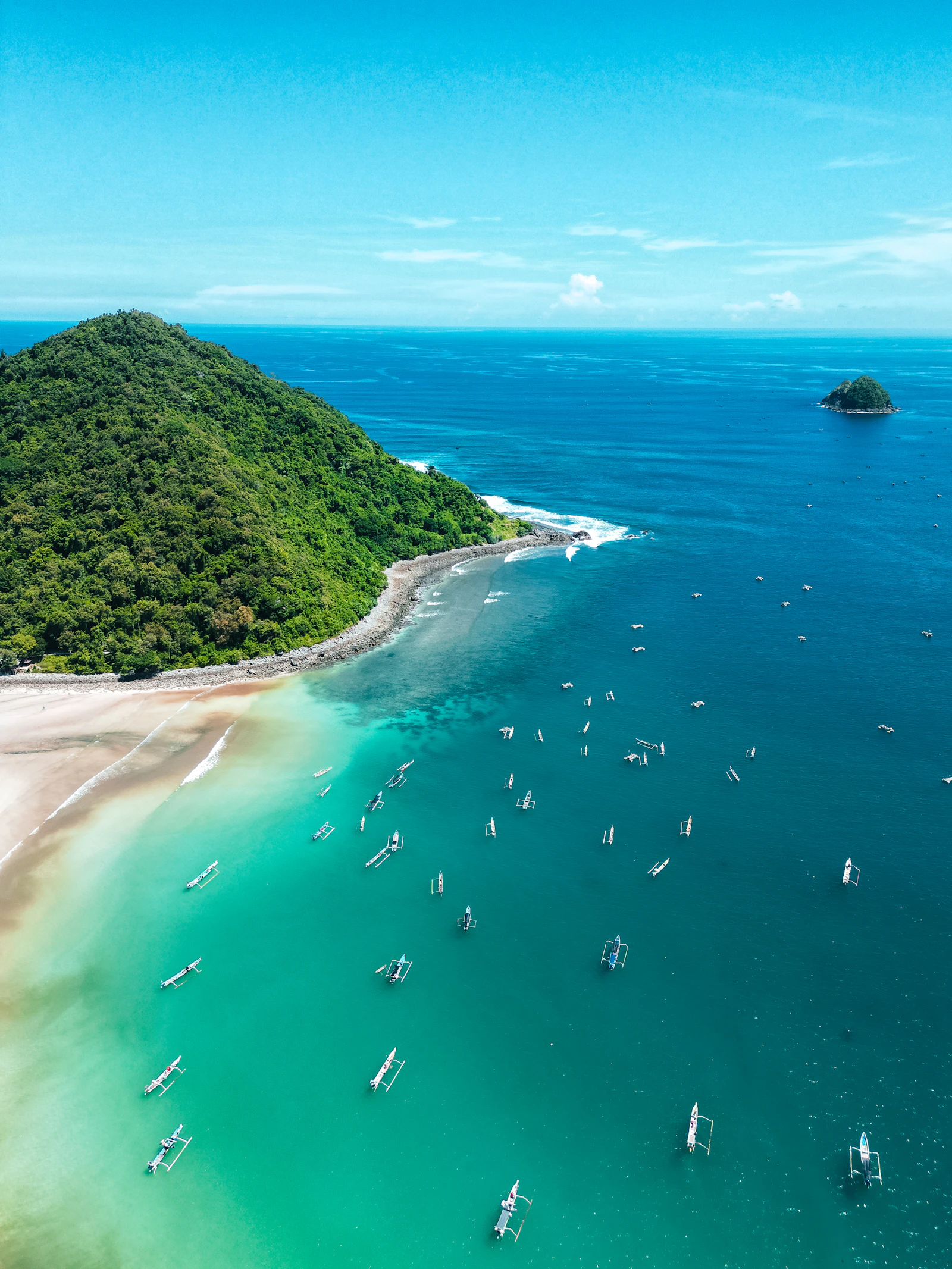 Turquoise sea and green mountains on the coast of Lombok