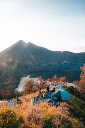 Camping on a mountain overlooking a serene lake.
