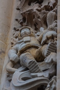 A stone carving depicts an astronaut figure.