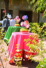 Colorful tables are set for an outdoor event.