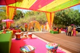 A vibrant outdoor event decorated in colorful tents.