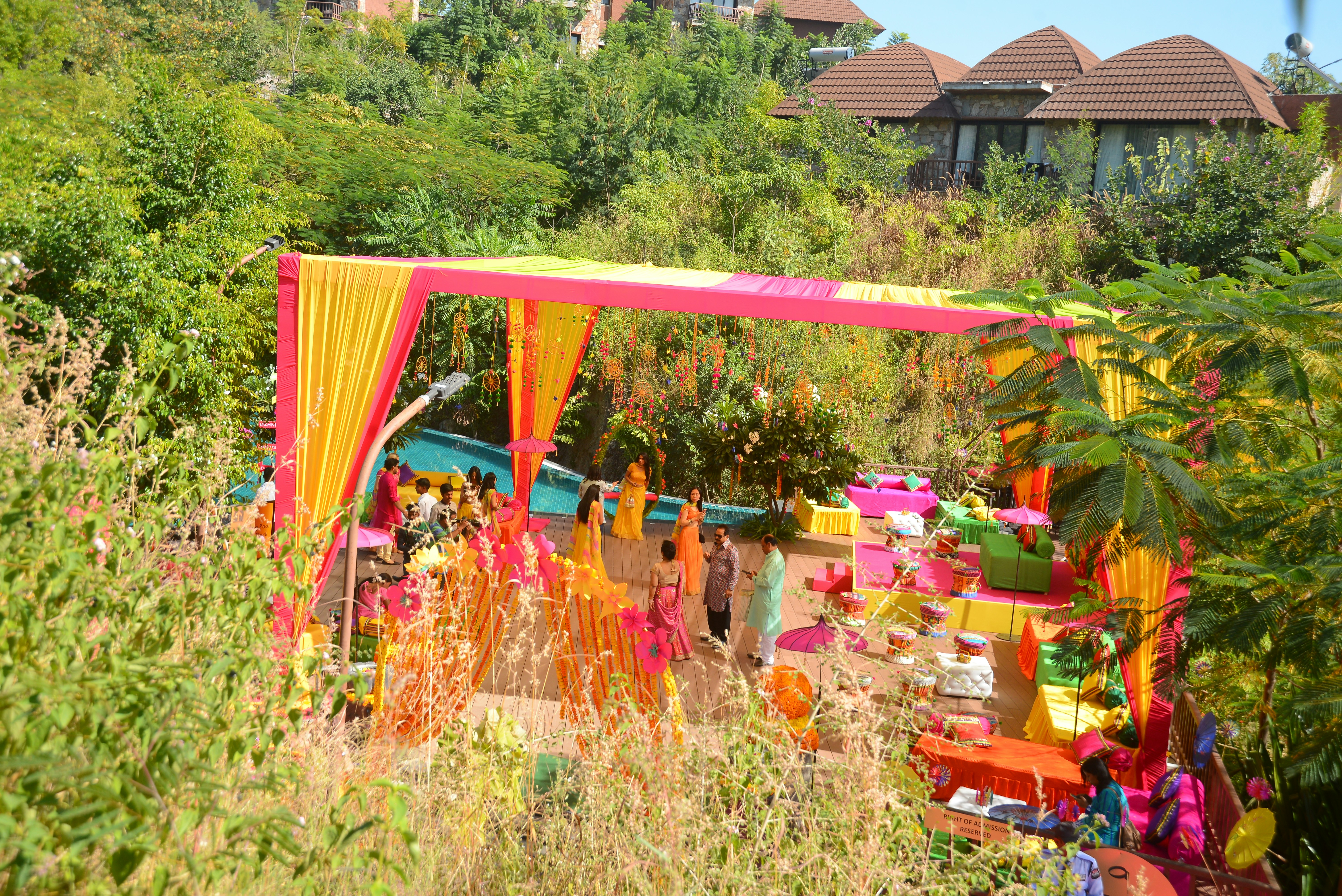 An outdoor wedding celebration with colorful decorations.