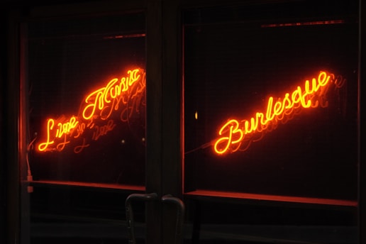 Neon signs advertise "live music" and "burlesque."