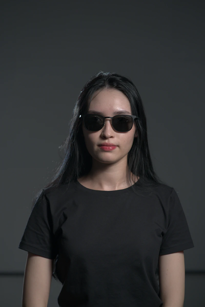 Woman in sunglasses on purple studio background