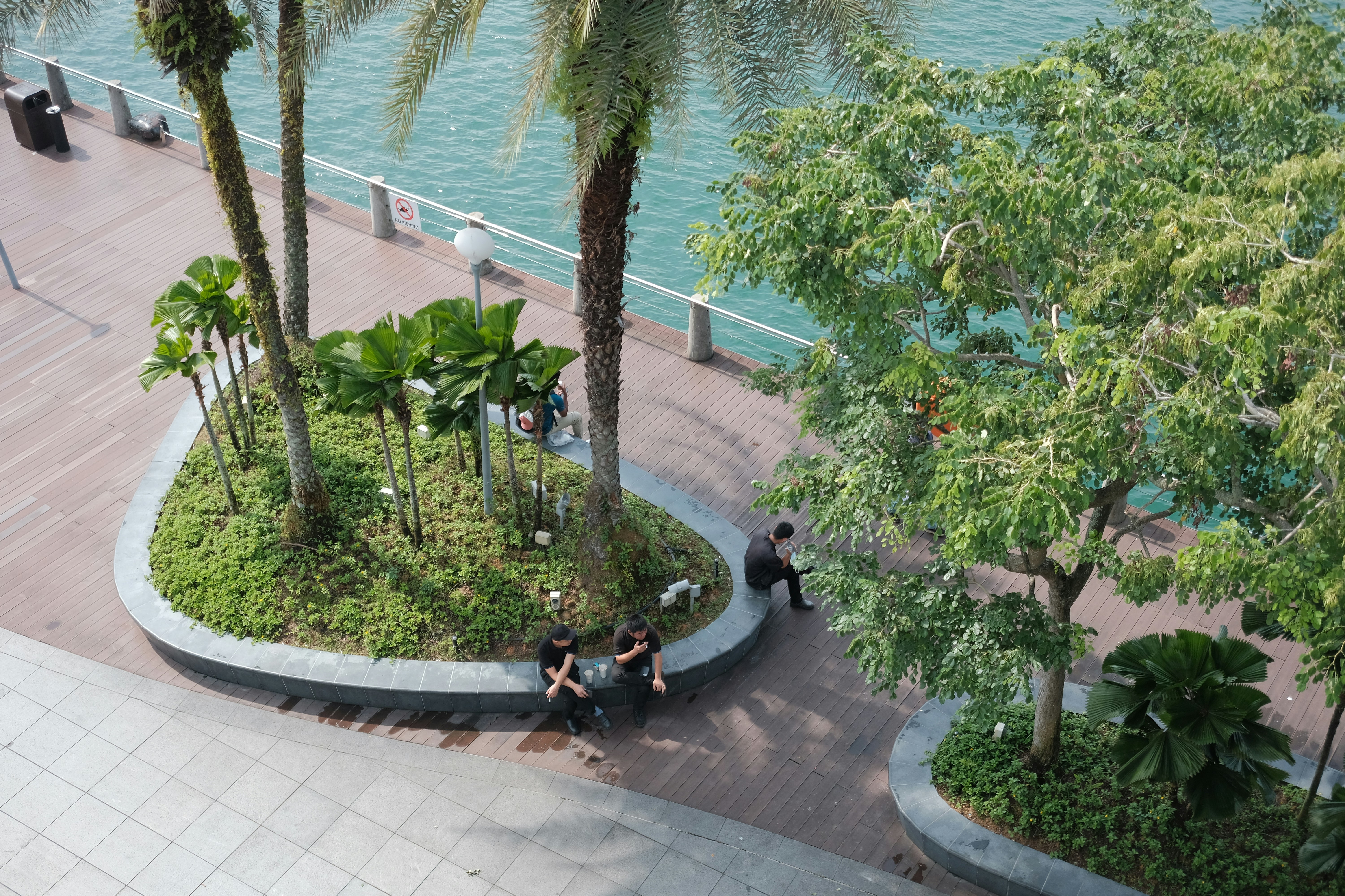 People relax near a waterfront park area.