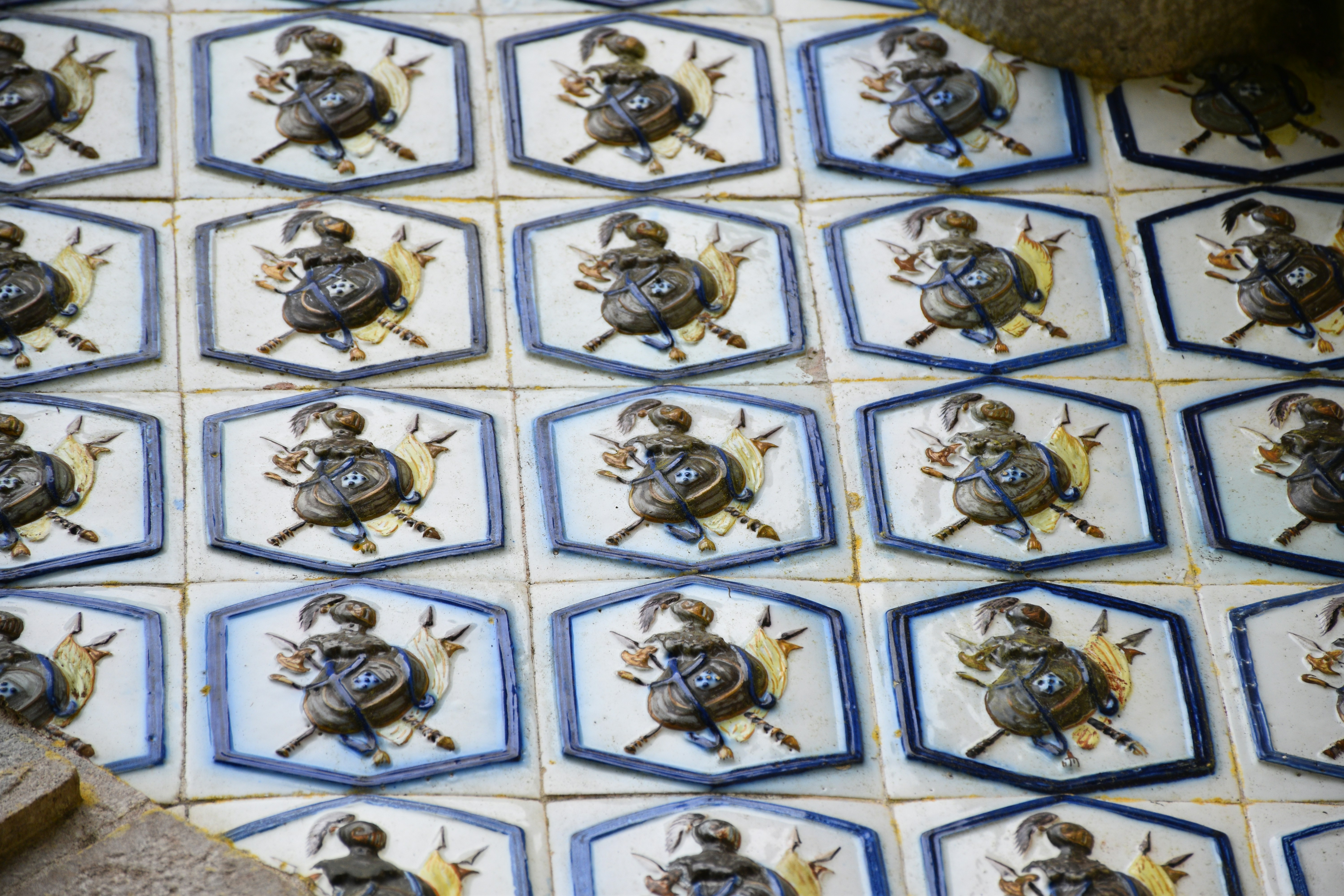 Tiles with a repeating design are on display.