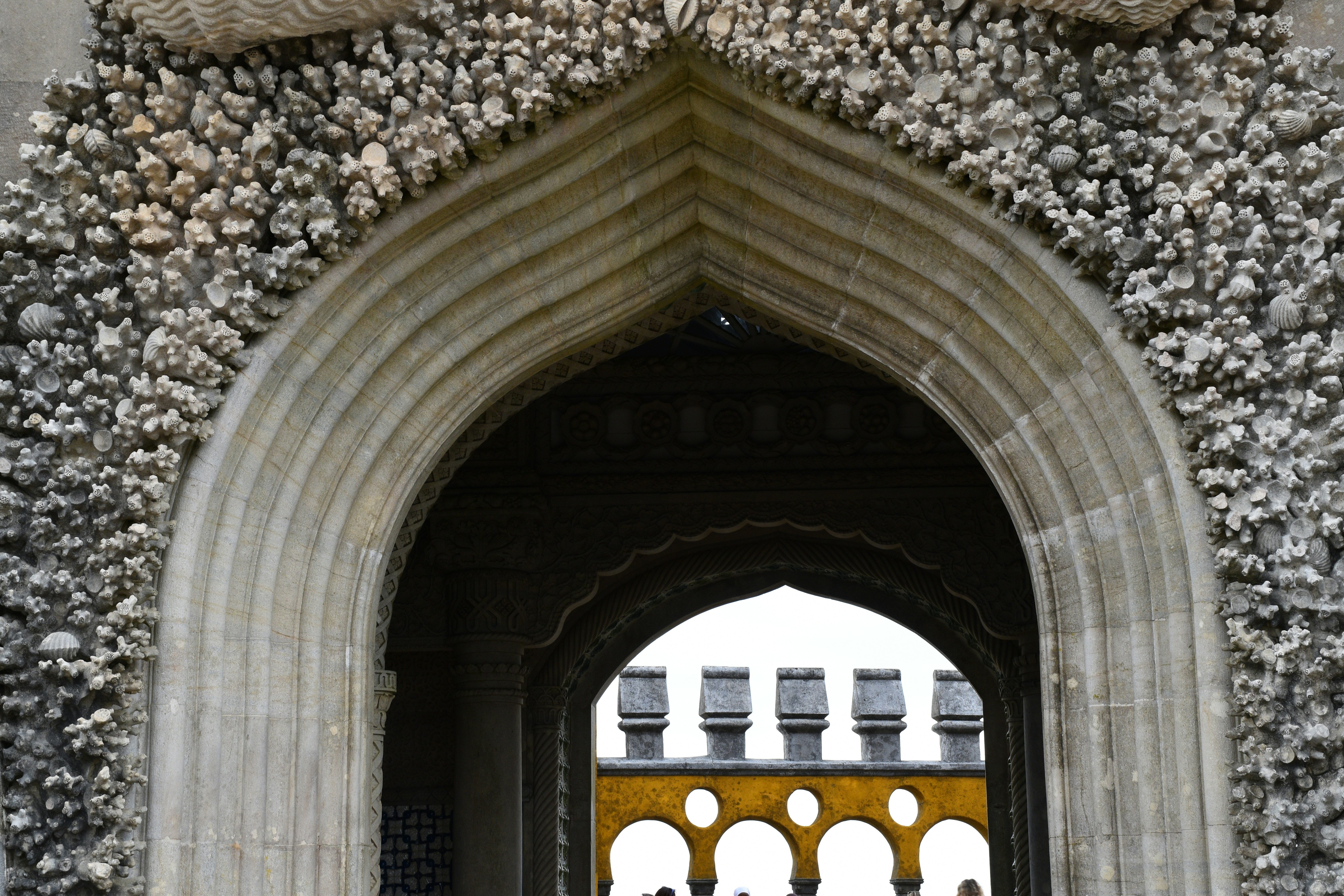 An arched doorway leads to a castle.
