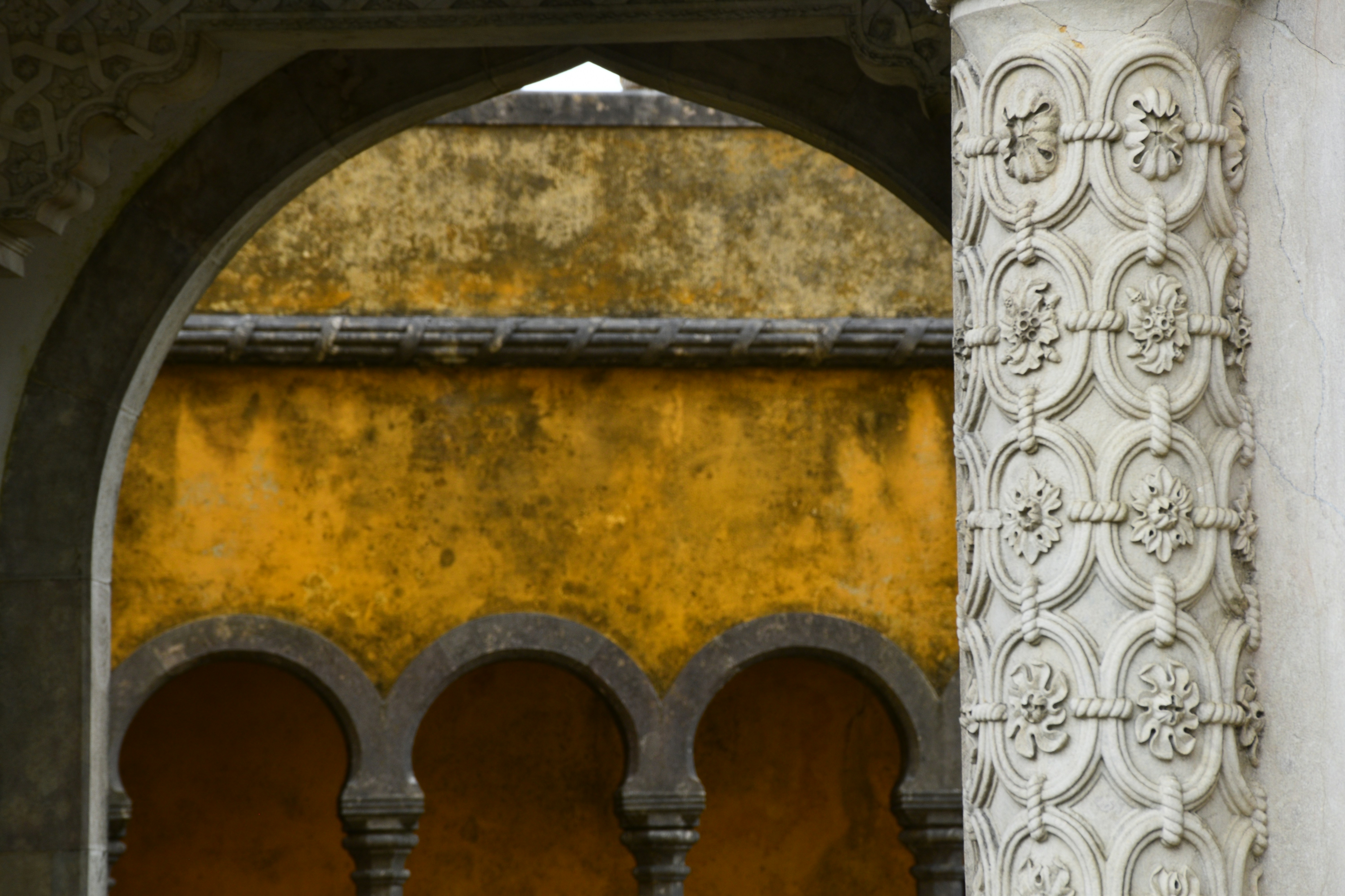 Arches, columns, and a yellow wall.