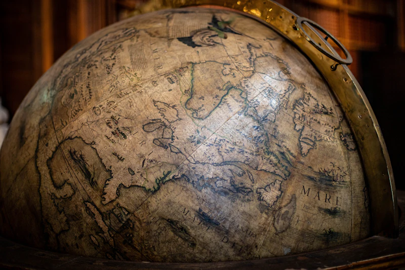 An old globe surrounded by maps