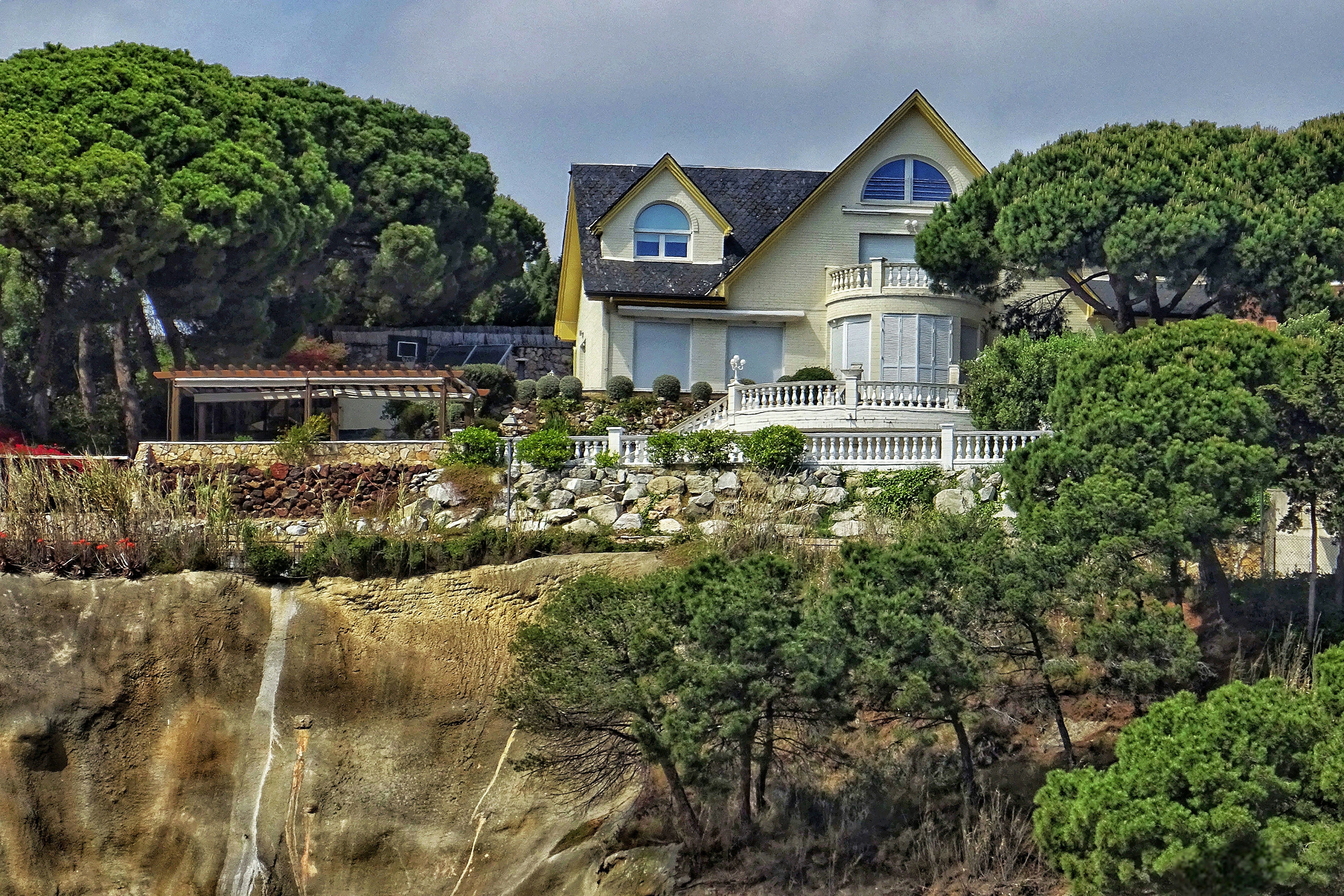 A luxurious house sits amidst lush greenery.