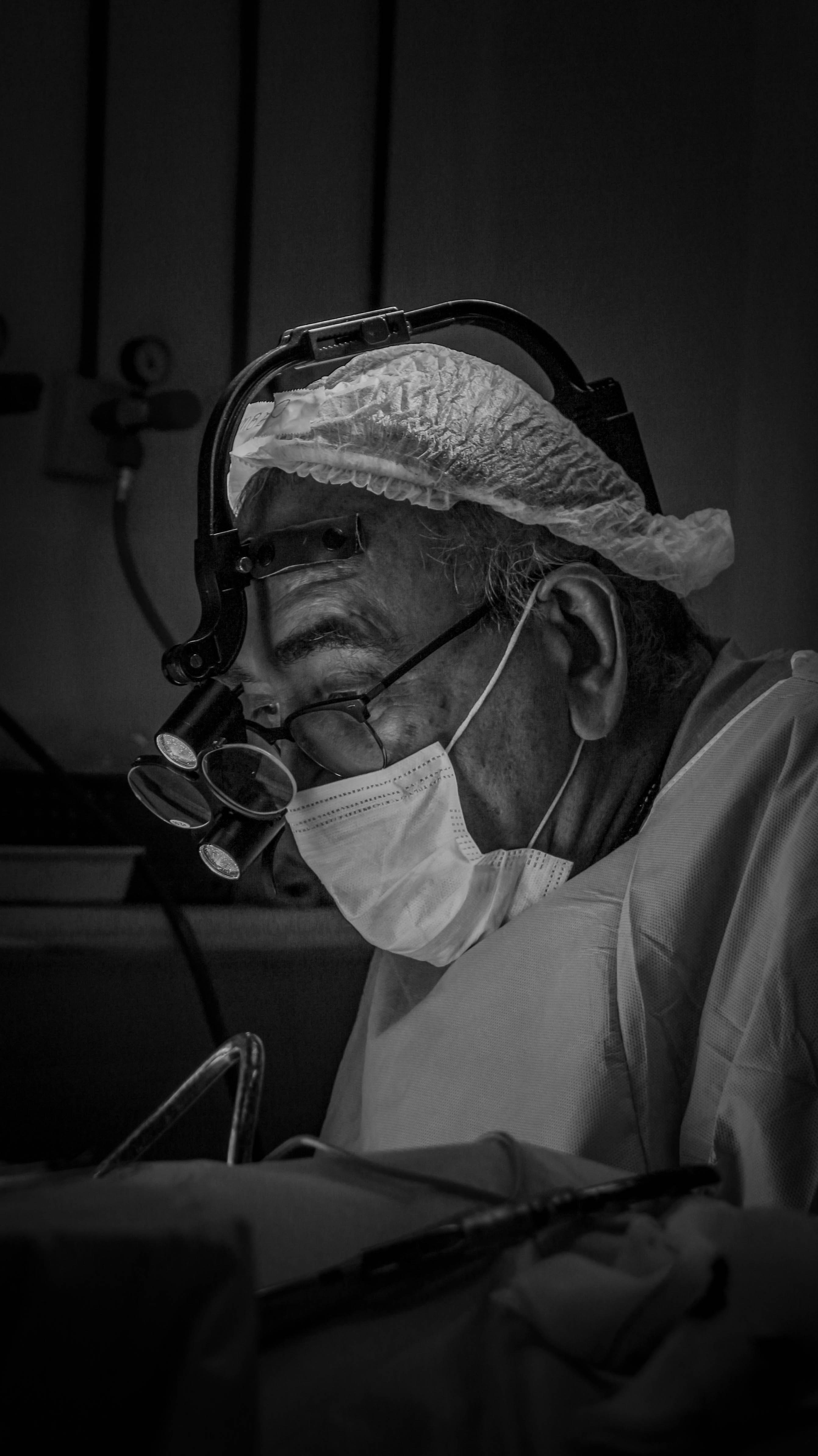 Surgeon focused on an operation in progress.