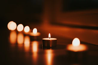 Candles glow warmly in the dim light