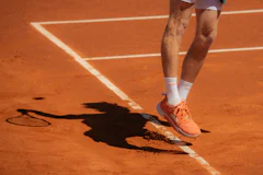 Tennis player jumping to serve the ball