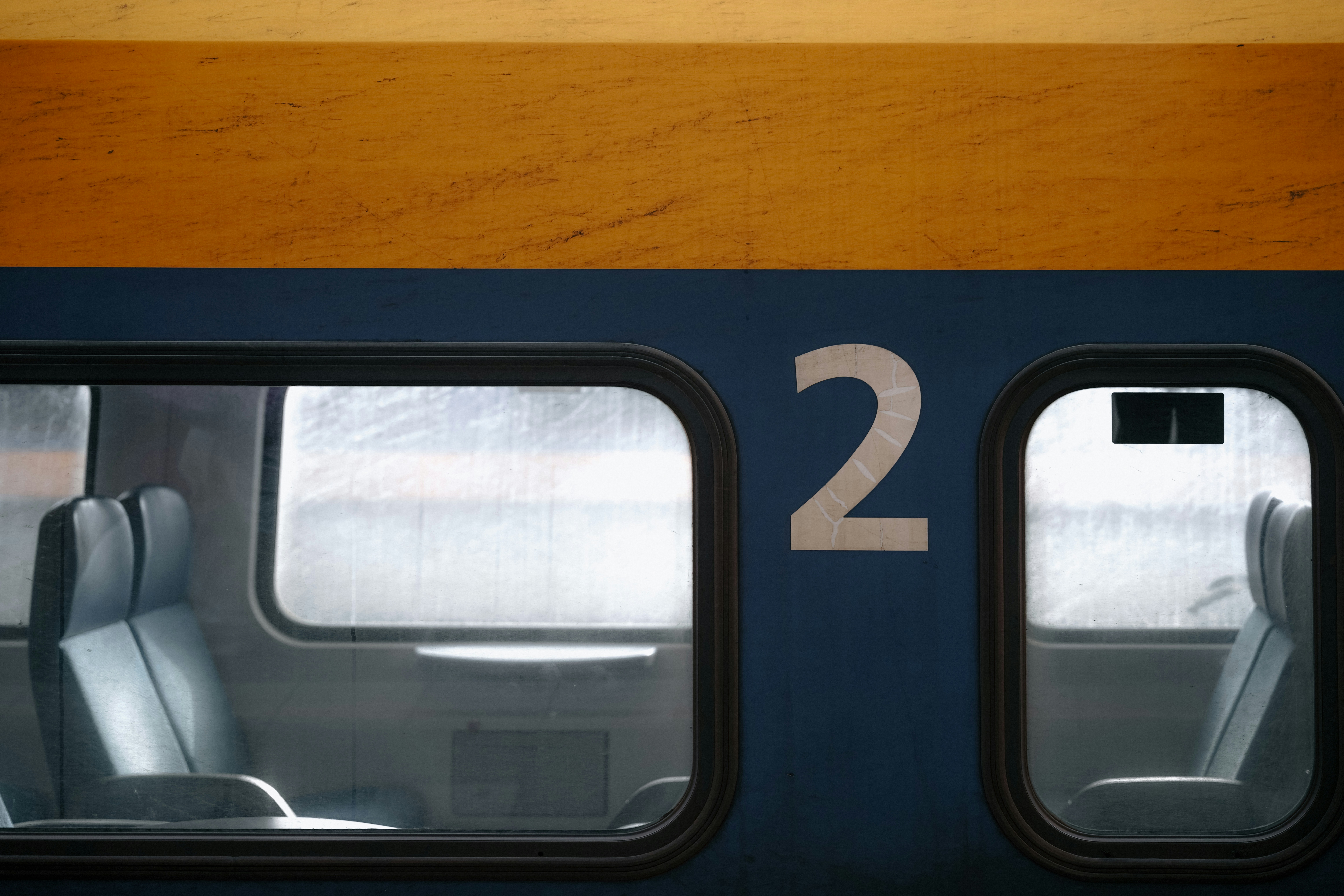 A train interior with the number two is shown.