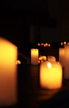 Burning candles illuminating a dark space.