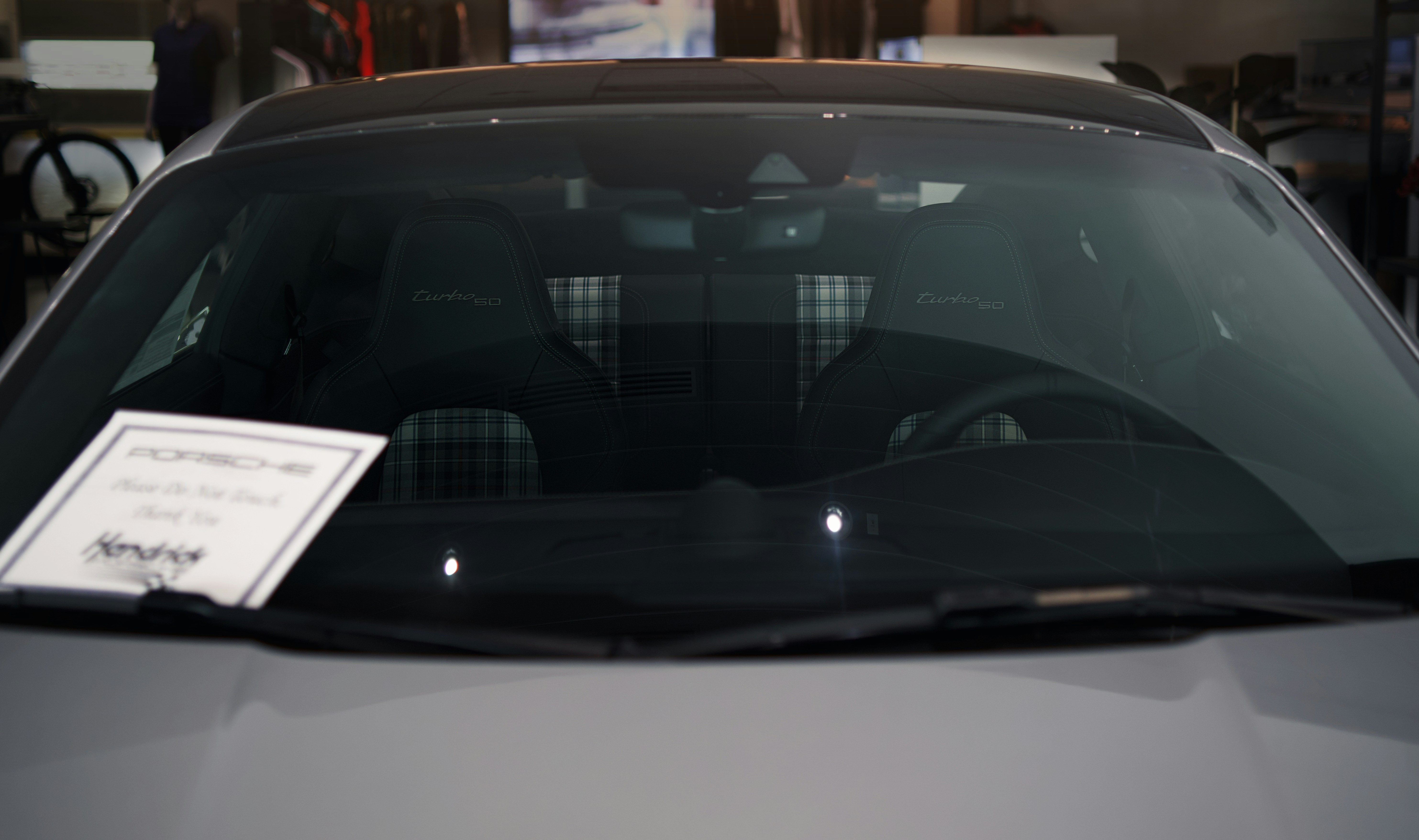 Professional automotive photography shoot of Porsche German sports car vehicles at a Hendricks car dealership.