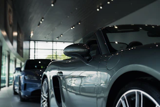 Luxury cars are on display in a showroom.