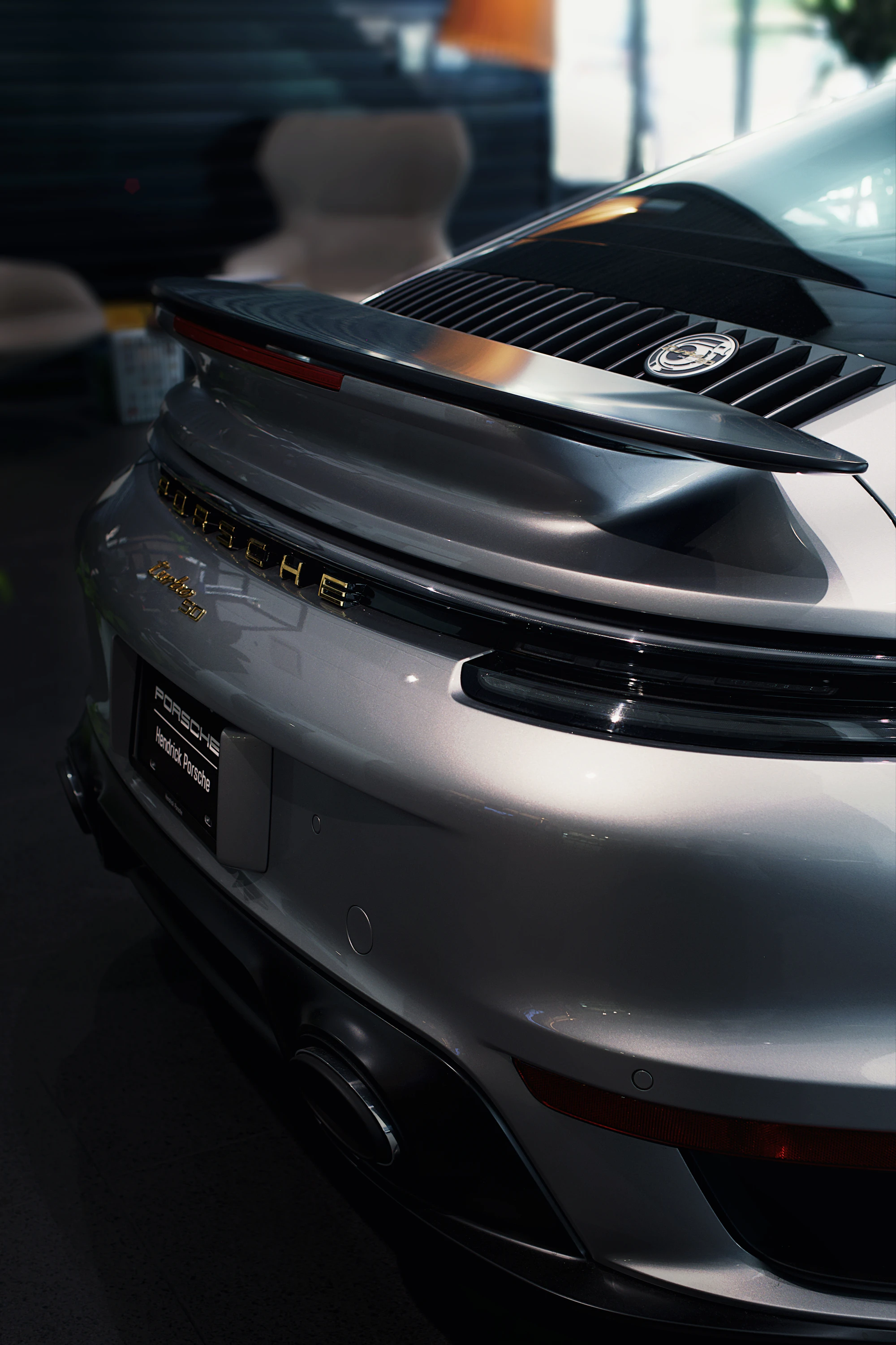 Silver Porsche 911 Turbo S with a mirror finish in the studio