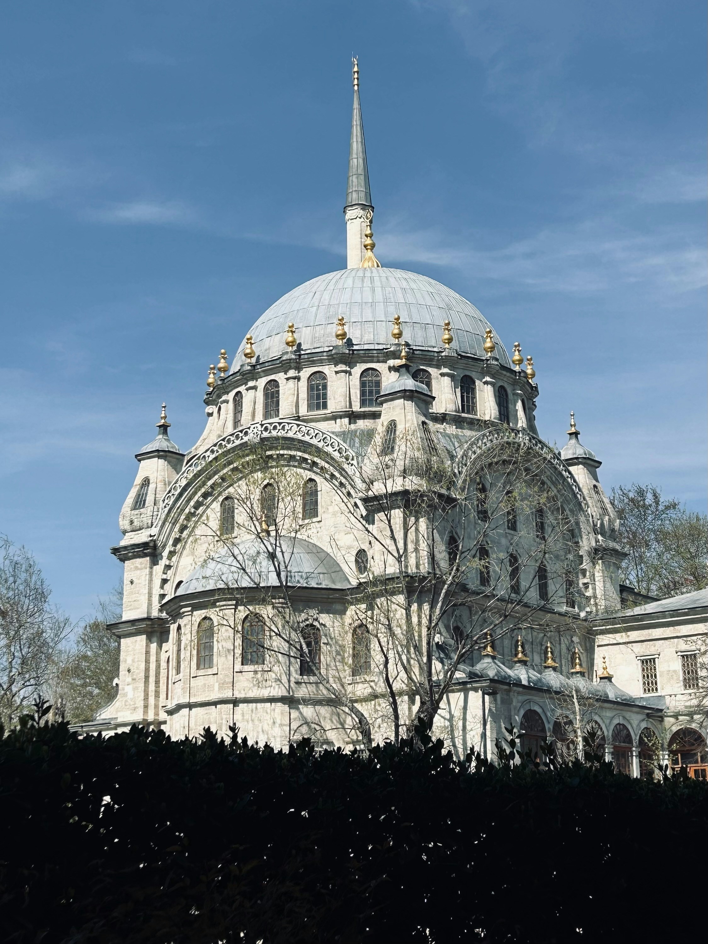 A beautiful mosque stands against a blue sky.