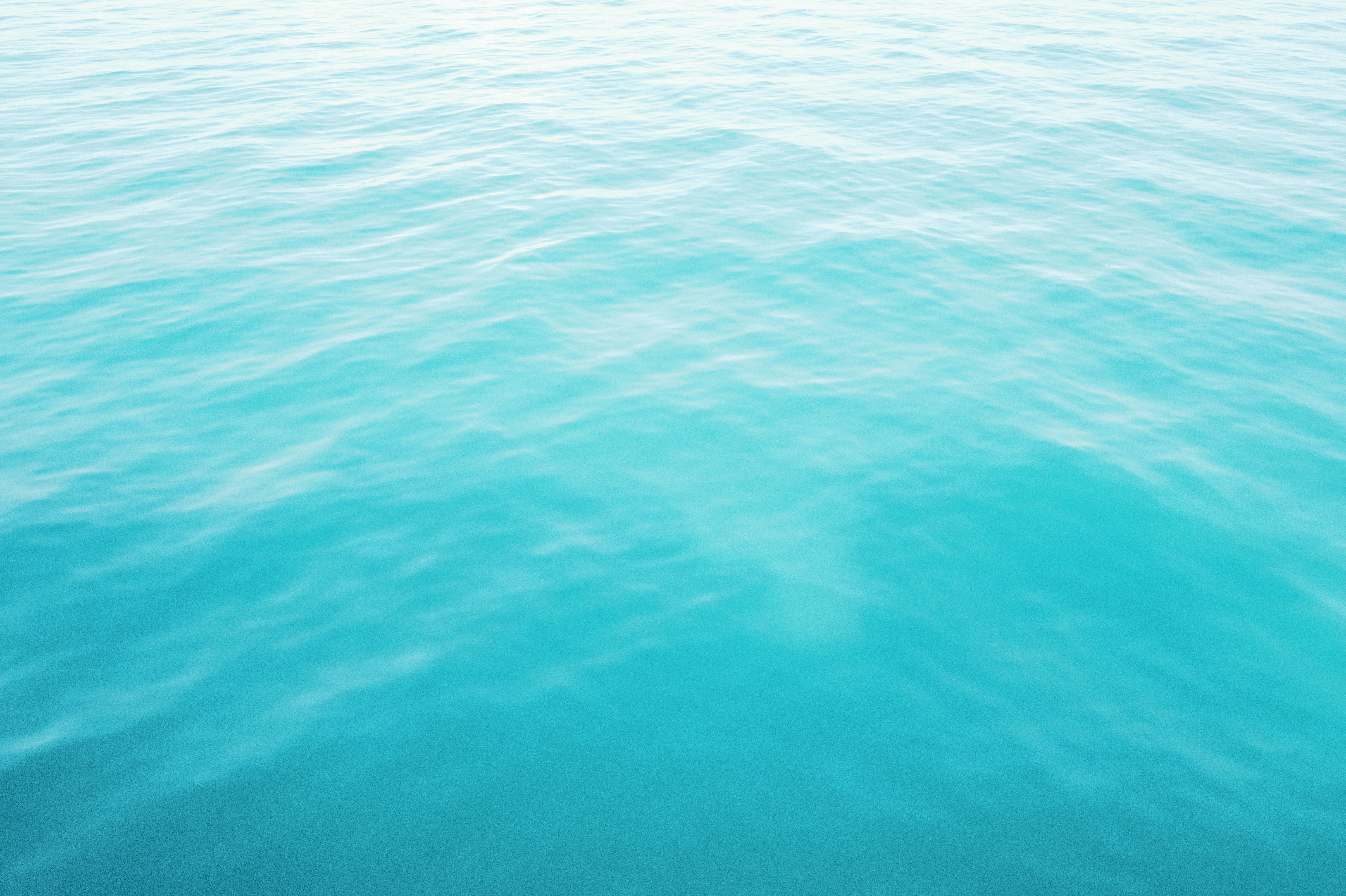 Turquoise water gently ripples in the sunlight.