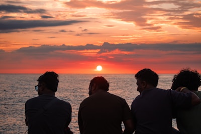 Friends watch the sunset together.