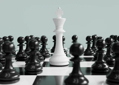 White king stands surrounded by black pawns.